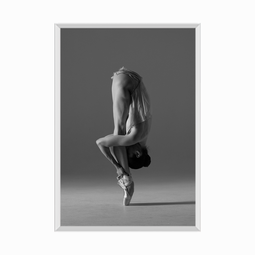 Young beautiful ballet dancer is posing in studio