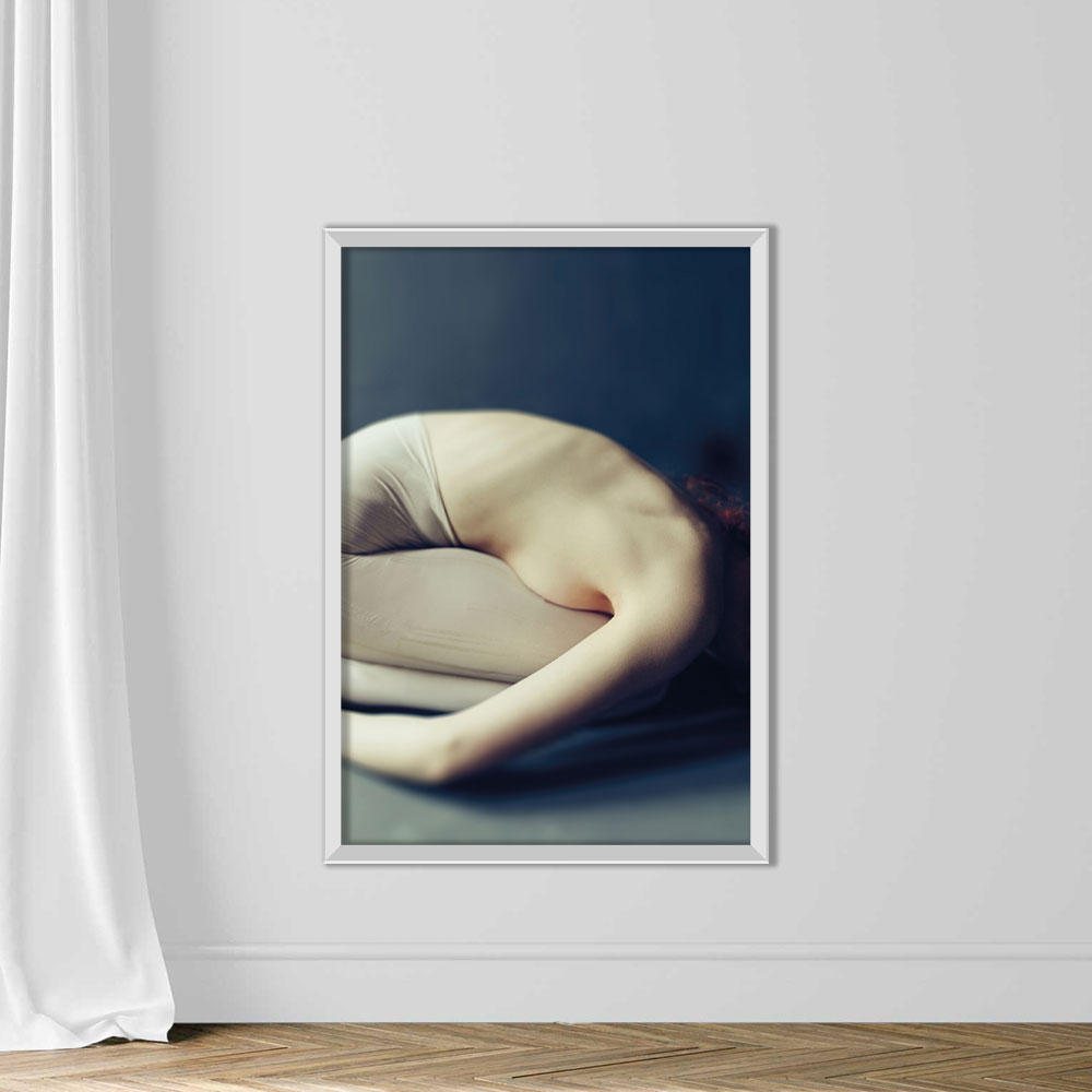 Woman curled up in the fetal position - Image 2